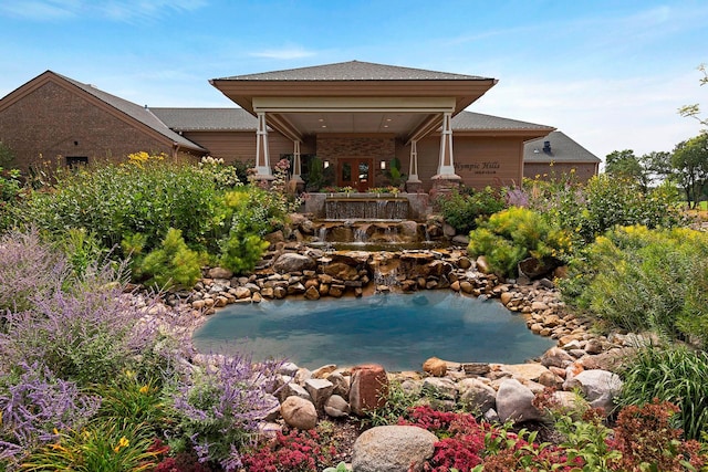 9378 Olympia Dr, Eden Prairie, MN 55347 - rear view of property with a small pond and roof with shingles