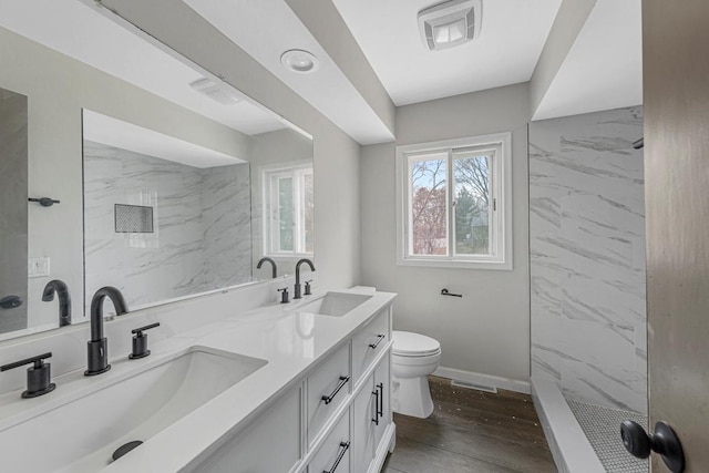 3633 Robinwood Ter, Minnetonka, MN 55305 - full bath with toilet, double vanity, a shower, wood finished floors, and baseboards