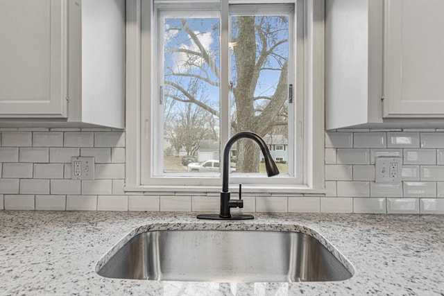 3633 Robinwood Ter, Minnetonka, MN 55305 - kitchen view of a sink, tasteful backsplash, and light stone countertops