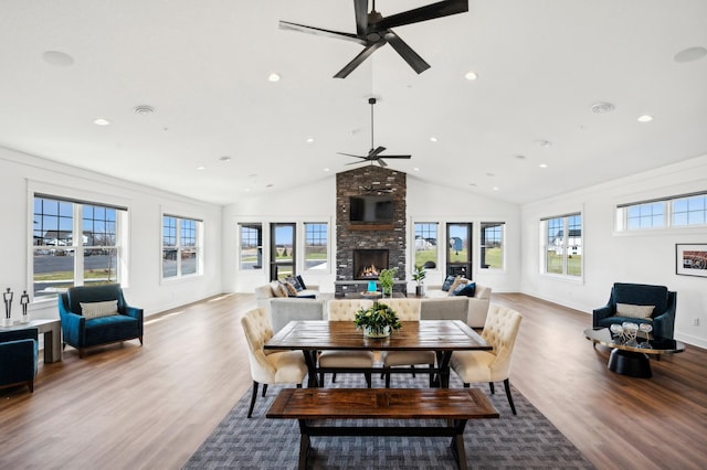 7581 Norway Ln, Lino Lakes, MN 55038 - dining space featuring ceiling fan, a large fireplace, recessed lighting, light wood-style flooring, and high vaulted ceiling