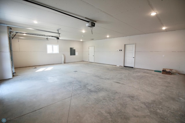 garage with a garage door opener and electric panel