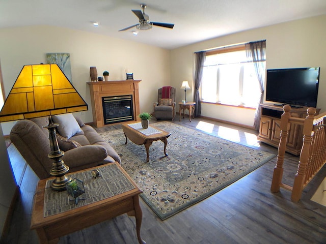 living area with ceiling fan, wood finished floors, a glass covered fireplace, and recessed lighting