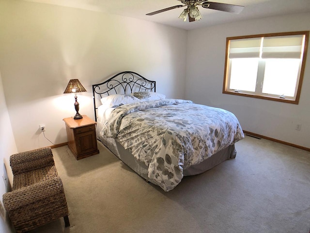 carpeted bedroom with baseboards and ceiling fan