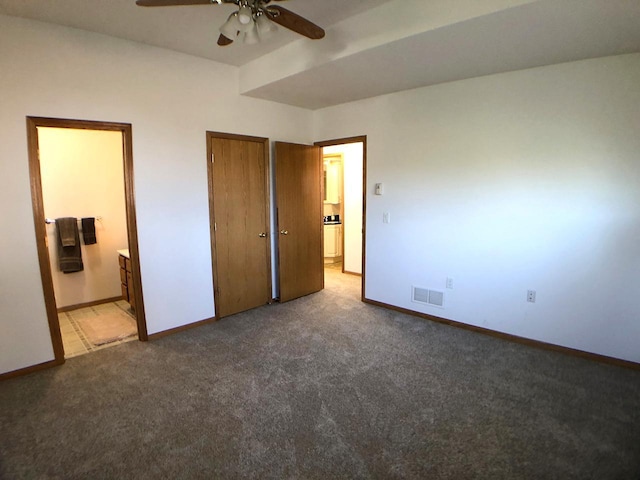 unfurnished bedroom with carpet, baseboards, and connected bathroom