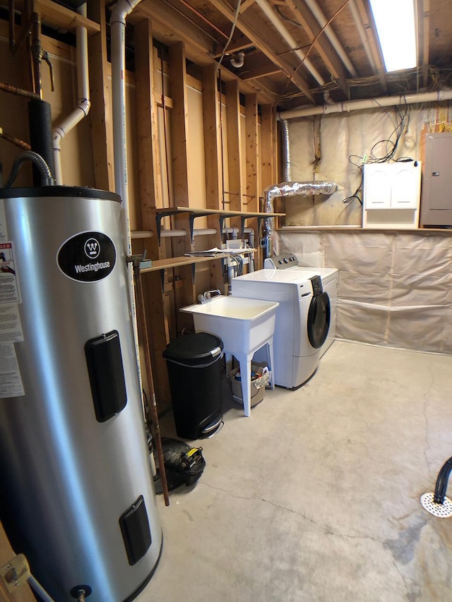 unfinished basement featuring water heater, electric panel, washer and clothes dryer, and a sink