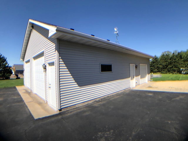 view of side of property featuring a detached garage