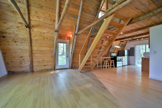 28435 392nd St, Browerville, MN 56438 - empty room with hardwood / wood-style floors, wood ceiling, beam ceiling, stairs, and wooden walls