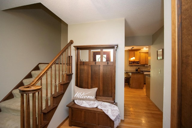 196 Mary Cir, North Mankato, MN 56003 - foyer entrance featuring light wood-style floors, stairs, and a textured ceiling