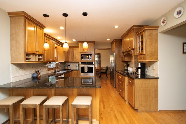 196 Mary Cir, North Mankato, MN 56003 - kitchen featuring stainless steel appliances, a sink, brown cabinetry, and recessed lighting