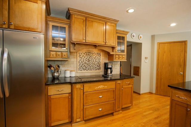 196 Mary Cir, North Mankato, MN 56003 - kitchen with stainless steel refrigerator, black electric stovetop, tasteful backsplash, light wood-style flooring, and brown cabinets