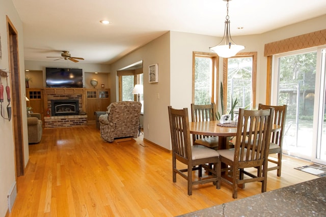 196 Mary Cir, North Mankato, MN 56003 - dining room featuring ceiling fan, plenty of natural light, light wood-style flooring, a brick fireplace, and recessed lighting
