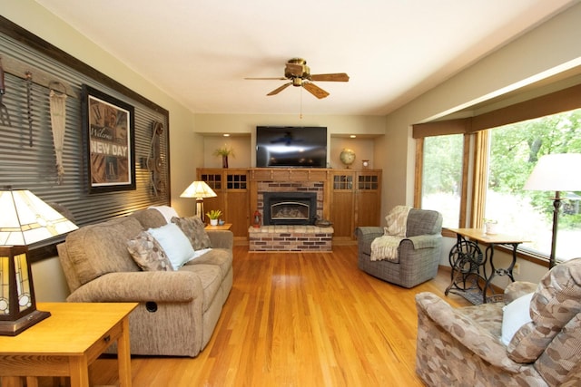 196 Mary Cir, North Mankato, MN 56003 - living area featuring ceiling fan, wood finished floors, and a brick fireplace