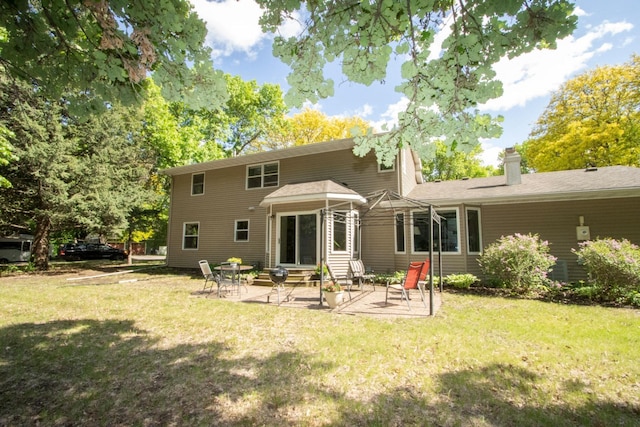 196 Mary Cir, North Mankato, MN 56003 - back of property with entry steps, a patio area, a yard, and a chimney