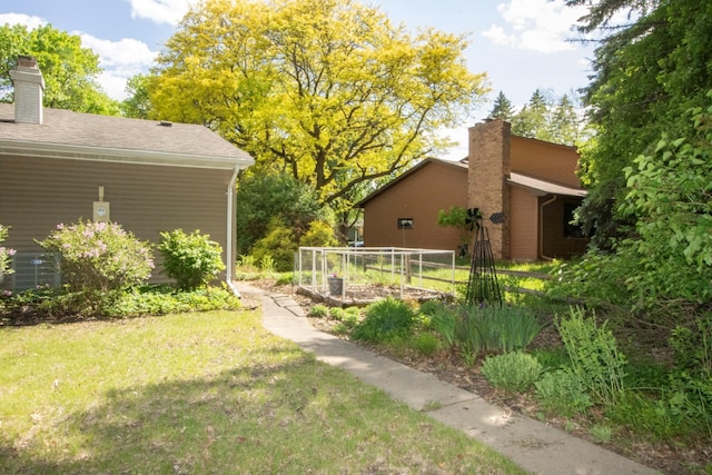 196 Mary Cir, North Mankato, MN 56003 - view of grassy yard featuring a garden