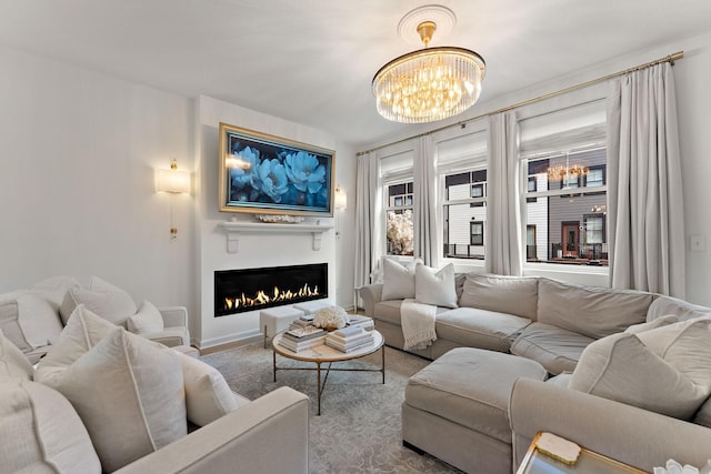 870 Mount Curve Blvd Unit F, Saint Paul, MN 55116 - living room with a chandelier, a warm lit fireplace, and baseboards