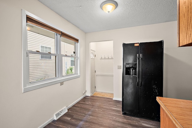 4625 Lyndale Ave N, Minneapolis, MN 55412 - kitchen with black refrigerator with ice dispenser, dark wood-style floors, a textured ceiling, and baseboards