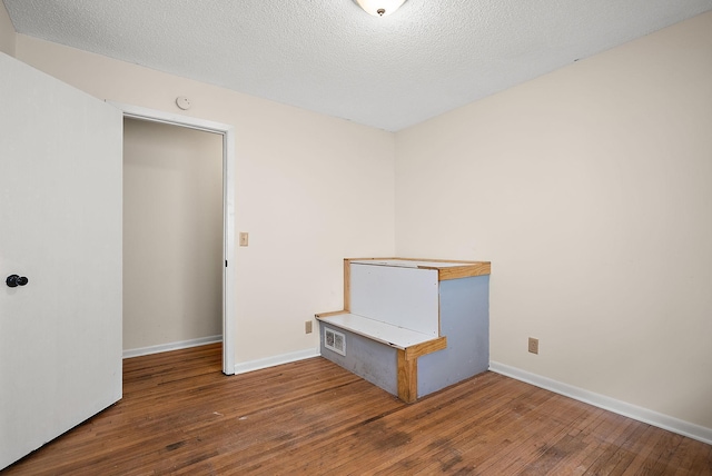 4625 Lyndale Ave N, Minneapolis, MN 55412 - unfurnished room featuring hardwood / wood-style floors, baseboards, and a textured ceiling