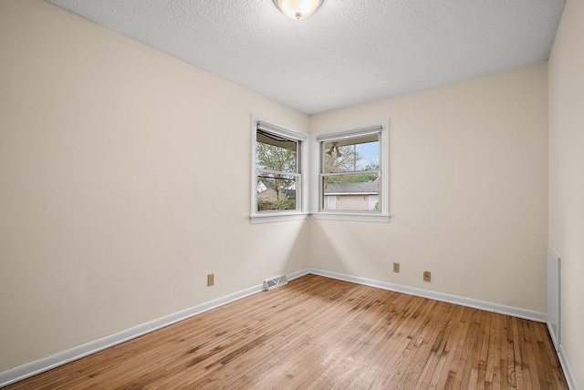 4625 Lyndale Ave N, Minneapolis, MN 55412 - empty room featuring baseboards, light wood-style flooring, and a textured ceiling
