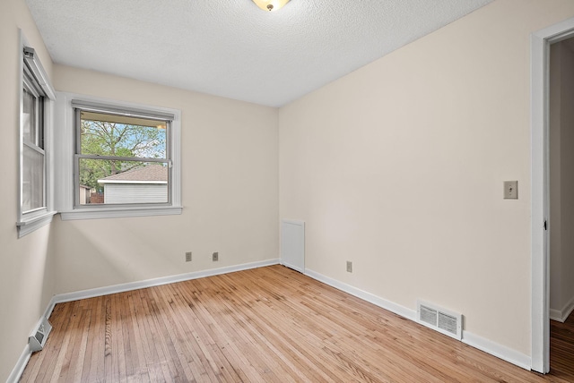 4625 Lyndale Ave N, Minneapolis, MN 55412 - spare room with wood-type flooring, baseboards, and a textured ceiling