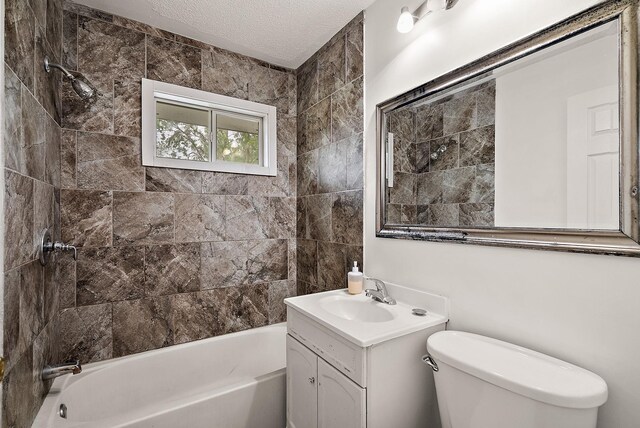 4625 Lyndale Ave N, Minneapolis, MN 55412 - bathroom with toilet, vanity, a textured ceiling, and tub / shower combination