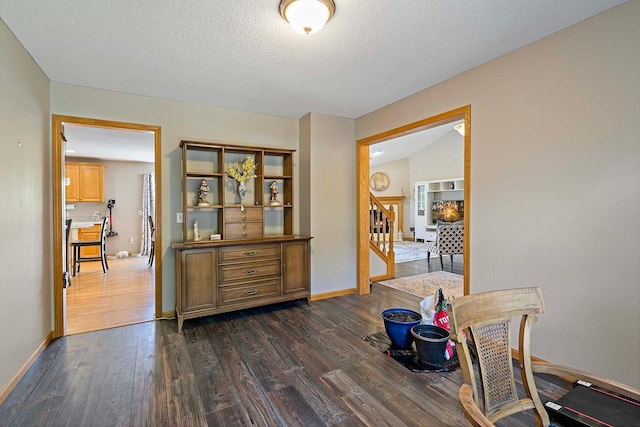 5901 106th Ave N, Brooklyn Park, MN 55443 - corridor featuring dark wood-style floors, stairs, and a textured ceiling