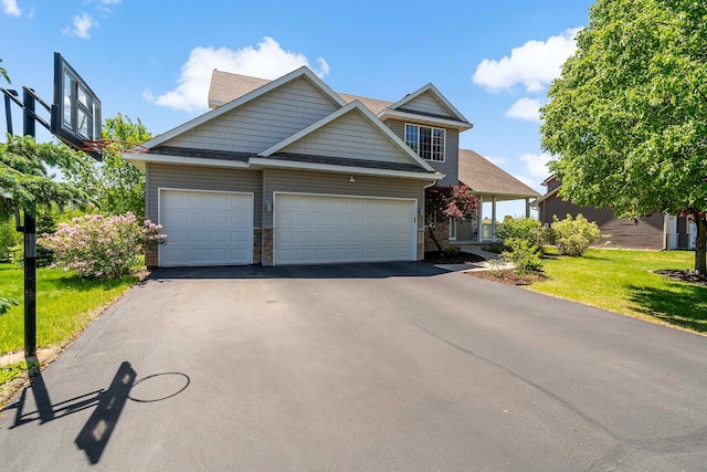 5901 106th Ave N, Brooklyn Park, MN 55443 - view of front of property featuring asphalt driveway, a garage, and a front lawn