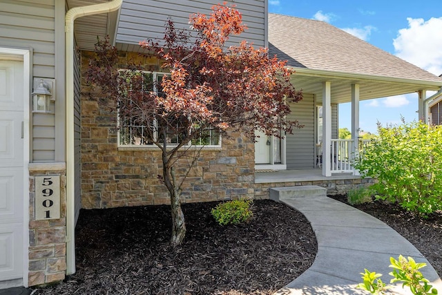 5901 106th Ave N, Brooklyn Park, MN 55443 - entrance to property featuring a porch, a shingled roof, and stone siding