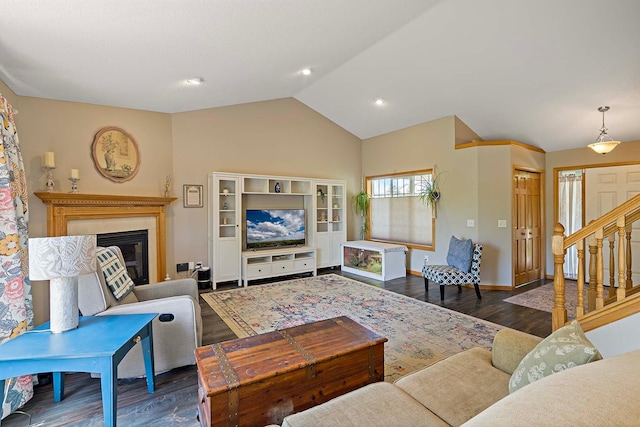 5901 106th Ave N, Brooklyn Park, MN 55443 - living room featuring wood finished floors, lofted ceiling, a glass covered fireplace, and stairs