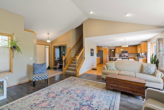 5901 106th Ave N, Brooklyn Park, MN 55443 - living area featuring healthy amount of natural light, light wood-style floors, stairs, high vaulted ceiling, and recessed lighting