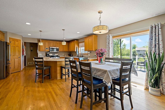 5901 106th Ave N, Brooklyn Park, MN 55443 - dining room featuring a textured ceiling, recessed lighting, and light wood-style flooring