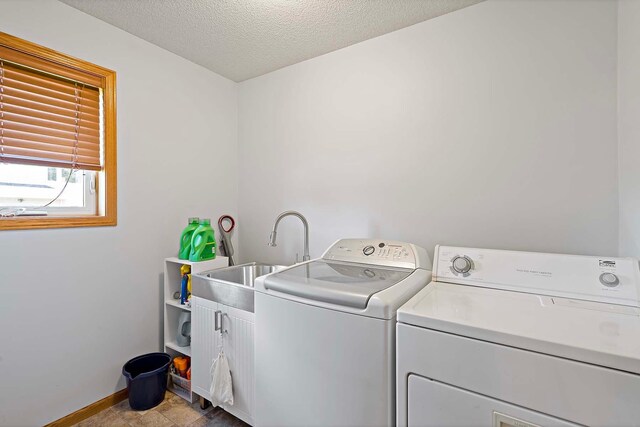 5901 106th Ave N, Brooklyn Park, MN 55443 - laundry room featuring cabinet space, separate washer and dryer, and a textured ceiling
