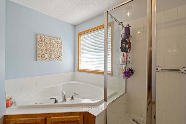 5901 106th Ave N, Brooklyn Park, MN 55443 - full bathroom featuring a stall shower, a jetted tub, and a textured ceiling