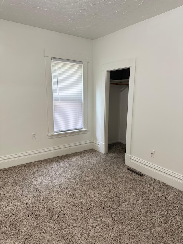 441 Minnesota Ave, Big Lake, MN 55309 - unfurnished bedroom featuring carpet flooring, a closet, and baseboards