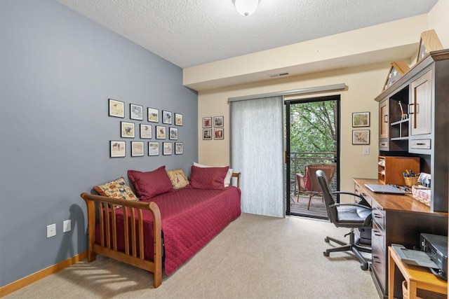 2565 Franklin Ave Unit 211, Saint Paul, MN 55114 - bedroom featuring carpet, a desk, access to outside, and a textured ceiling