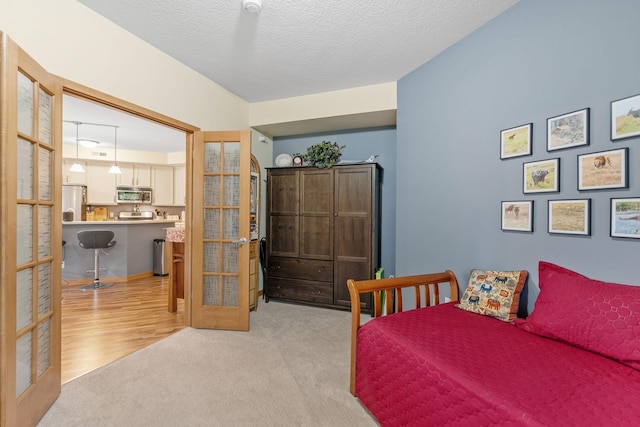 2565 Franklin Ave Unit 211, Saint Paul, MN 55114 - bedroom with french doors, fridge, and light carpet