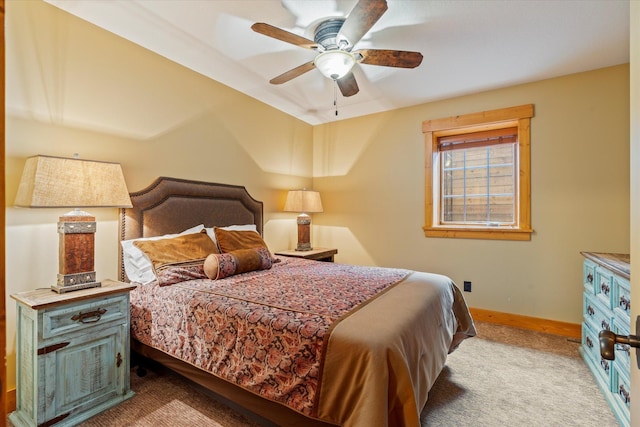 carpeted bedroom featuring baseboards and ceiling fan