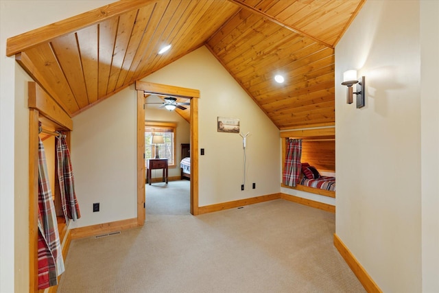 bonus room featuring lofted ceiling, carpet, wooden ceiling, baseboards, and a ceiling fan