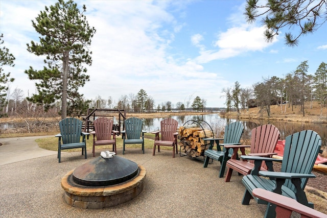 view of patio / terrace featuring an outdoor fire pit and a water view