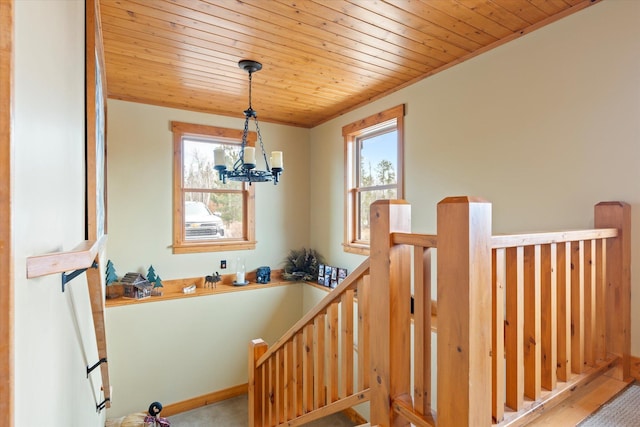 staircase featuring wood ceiling and a chandelier