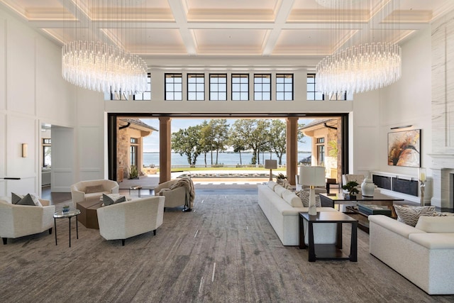 2770 Gale Rd, Woodland, MN 55391 - living room with a chandelier, a high ceiling, coffered ceiling, a water view, and healthy amount of natural light