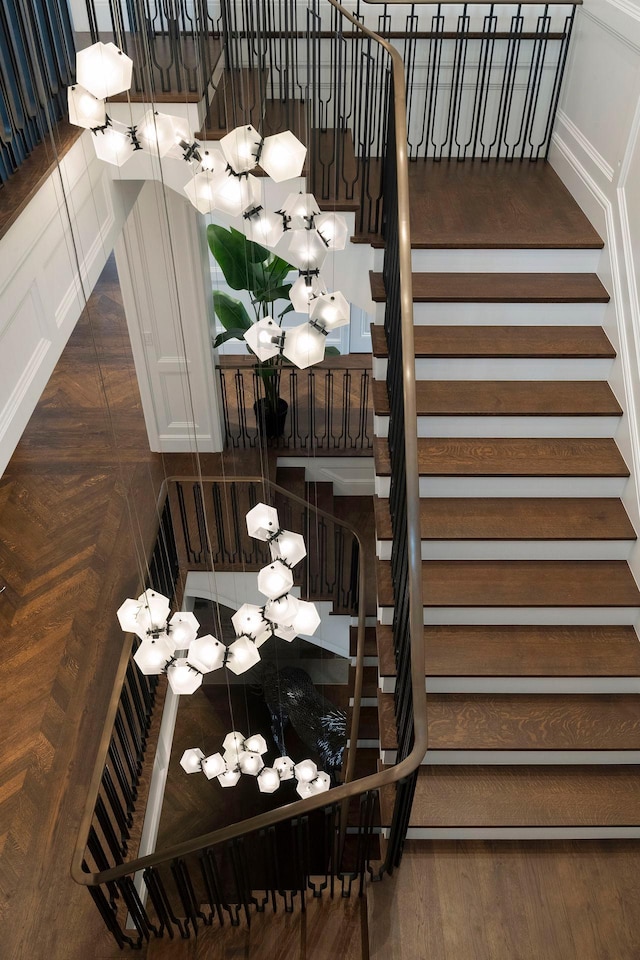 2770 Gale Rd, Woodland, MN 55391 - stairway with a chandelier and wood finished floors