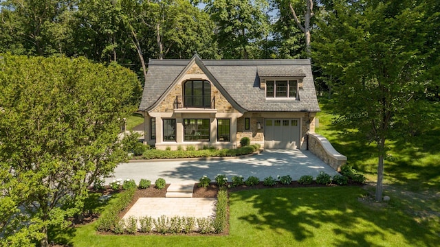 2770 Gale Rd, Woodland, MN 55391 - english style home featuring stone siding, concrete driveway, a front lawn, and a garage