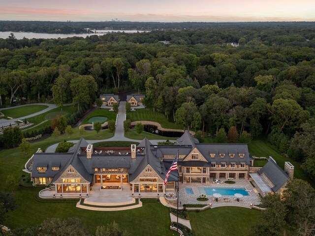 2770 Gale Rd, Woodland, MN 55391 - aerial view at dusk of a wooded view, view of pool area, and a water view
