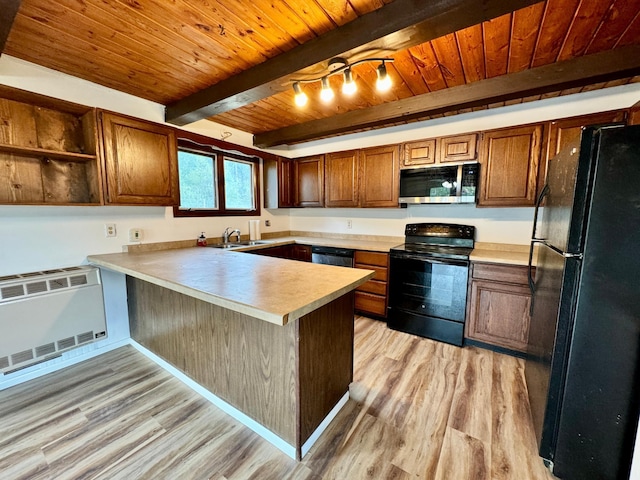 56279 350th St, Warroad, MN 56763 - kitchen with black appliances, a peninsula, light wood-style flooring, wooden ceiling, and light countertops