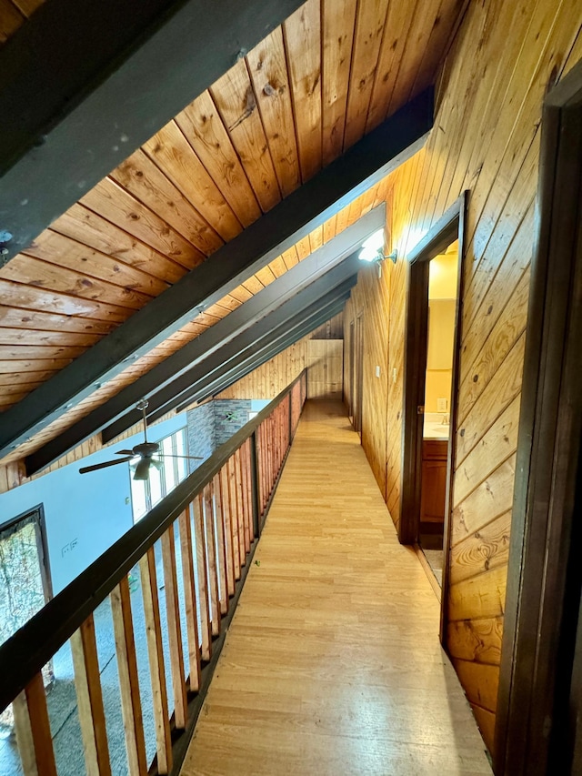 56279 350th St, Warroad, MN 56763 - hallway with wood ceiling, wood walls, light wood-style flooring, and beam ceiling
