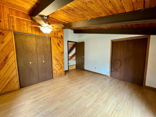 56279 350th St, Warroad, MN 56763 - unfurnished bedroom featuring beamed ceiling, wood finished floors, wood ceiling, baseboards, and wooden walls