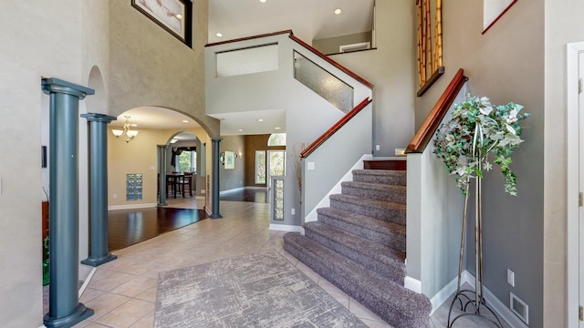 610 Main St, Adams, MN 55909 - entryway with arched walkways, decorative columns, a towering ceiling, tile patterned flooring, and stairs