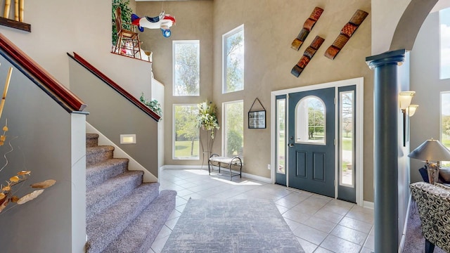 610 Main St, Adams, MN 55909 - foyer entrance with a high ceiling, tile patterned floors, healthy amount of natural light, baseboards, and stairs