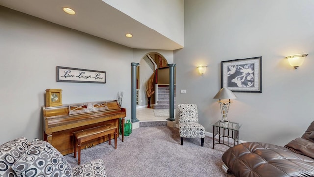 610 Main St, Adams, MN 55909 - living area with arched walkways, carpet floors, recessed lighting, baseboards, and decorative columns