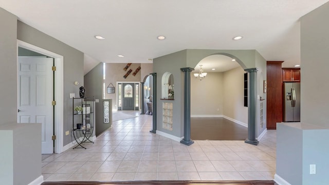 610 Main St, Adams, MN 55909 - foyer with arched walkways, light tile patterned flooring, decorative columns, recessed lighting, and baseboards